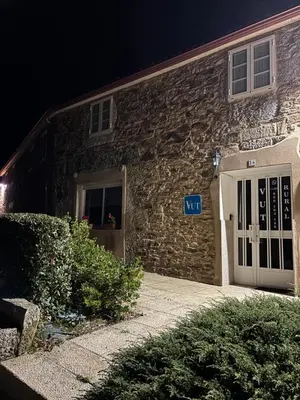 a stone building with a white door at night at VUT Boente 2 in Boente