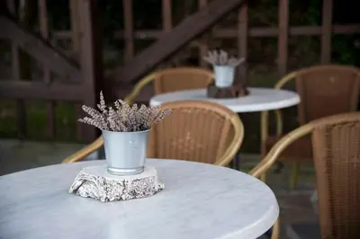 a white table with a vase with flowers on it at Hotel Rural Casona Trabadelo in Vegadeo