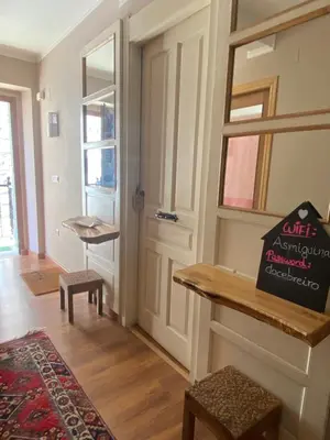 a living room with a door and a table at As Miguiñas do Cebreiro in Piedrafita