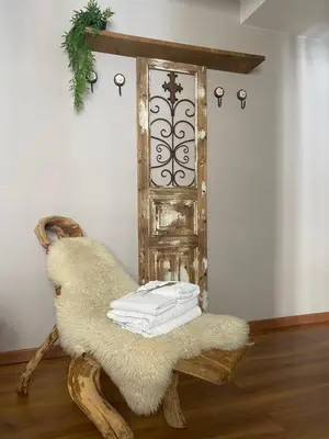 a chair with towels on it in a room with a door at As Miguiñas do Cebreiro in Piedrafita