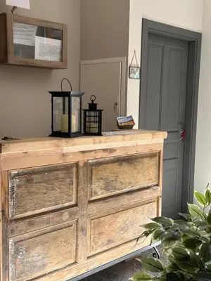 an old wooden dresser in a room with a door at As Miguiñas do Cebreiro in Piedrafita