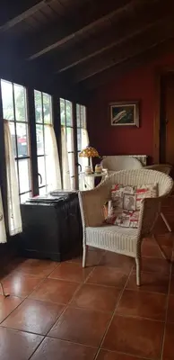 a living room with two chairs and a couch at Apartamentos Rurales Casa Pachona in Puerto de Vega