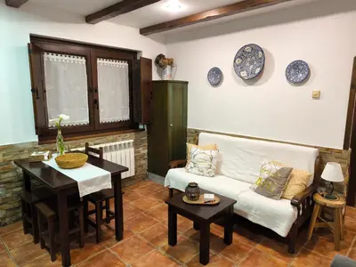a living room with a couch and a table at Apartamentos Rurales Casa Pachona in Puerto de Vega