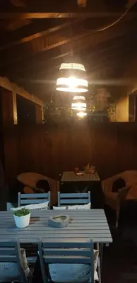 a dining room with a table and chairs and a chandelier at Apartamentos Rurales Casa Pachona in Puerto de Vega