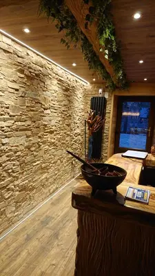 a room with a stone wall and a bowl on a counter at Casa Antón O Cebreiro in O Cebreiro
