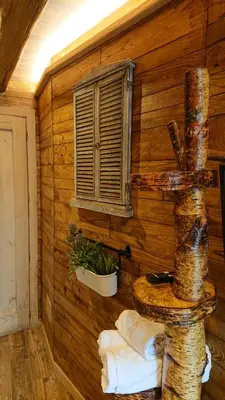 a room with a log wall with a window at Casa Antón O Cebreiro in O Cebreiro