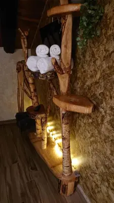 a wooden chair with towels on top of it at Casa Antón O Cebreiro in O Cebreiro