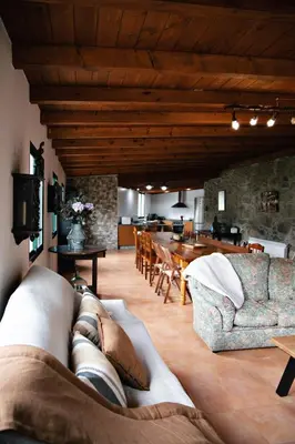 a person laying on a couch in a living room at Casa As Nogueiras in Deade