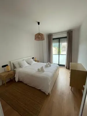 a bedroom with a large white bed and a window at Joaquín Potel in Caldas de Reis
