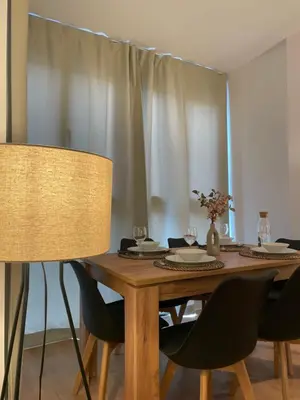 a dining room table with chairs and a wooden table sidx sidx sidx at Joaquín Potel in Caldas de Reis