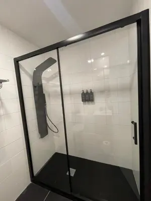 a shower in a bathroom with a glass door at Joaquín Potel in Caldas de Reis