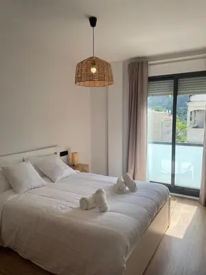 a bedroom with a large white bed with stuffed animals on it at Joaquín Potel in Caldas de Reis