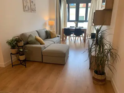 a living room with a couch and a table at Joaquín Potel in Caldas de Reis