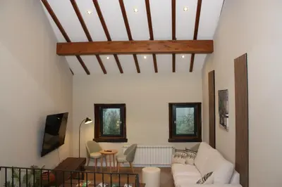 a living room with a couch and a table at Xanela Xures in Muiños