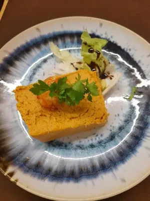 a white plate with a piece of food on it at Xanela Xures in Muiños