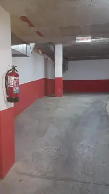 an empty parking garage with a red and white wall at Mirador do Xistral in Valle de Oro