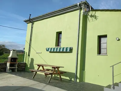 a small green building with a sign on it at Casa Rural de alquiler integro La Cantina de Villarmayor-Asturias in Villarmayor