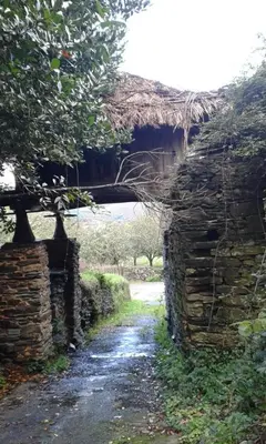 an old stone wall with a bridge over a road at Casa Rural de alquiler integro La Cantina de Villarmayor-Asturias in Villarmayor