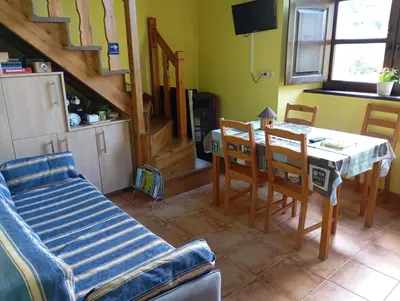 a dining room with a table and chairs in a room at Casa Rural de alquiler integro La Cantina de Villarmayor-Asturias in Villarmayor