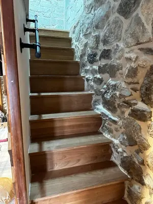 a set of stairs in front of a stone wall at A Ribeira in Castro Caldelas
