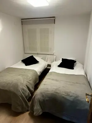 two beds sitting next to each other in a room at A Ribeira in Castro Caldelas