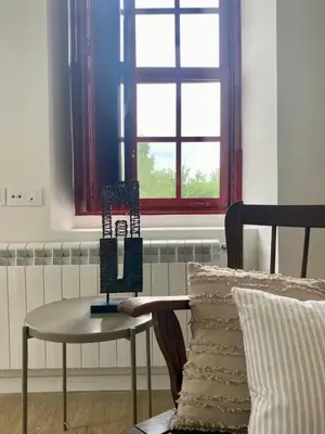 a table and a chair in a room with a window at El Balcón del Eume, Cantina Río Covés in Puentedeume