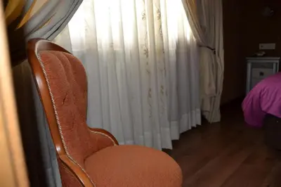 an orange chair sitting in front of a window at El Trasgu de Foncebadón in Foncebadón
