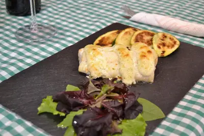 a plate of food and a salad on a table at El Trasgu de Foncebadón in Foncebadón