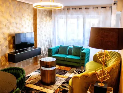 a living room with a couch and a television at Golden Home in Ourense