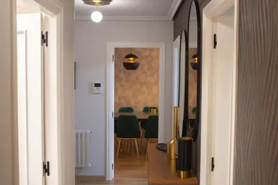a hallway leading to a dining room with a table at Golden Home in Ourense