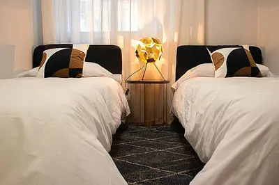 two beds sitting next to each other in a bedroom at Golden Home in Ourense