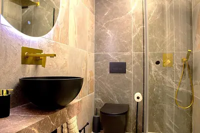 a bathroom with a black bowl sink and a shower at Golden Home in Ourense