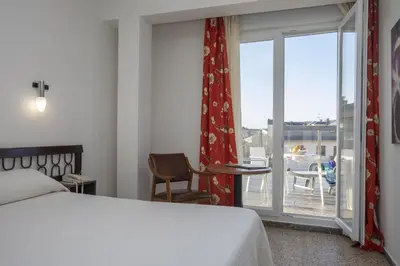 a bedroom with a bed and a window with a view at Hotel La Ruta in Tapia de Casariego