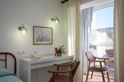 a room with two chairs and a table and a window at Hotel La Ruta in Tapia de Casariego