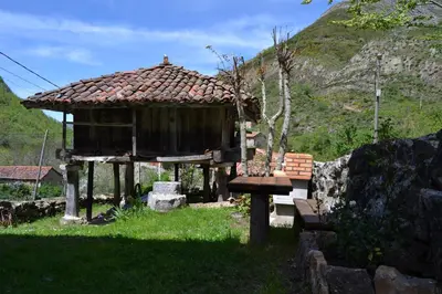a small hut with a bench in the grass at Casas Rurales Las Corradas in Éndriga