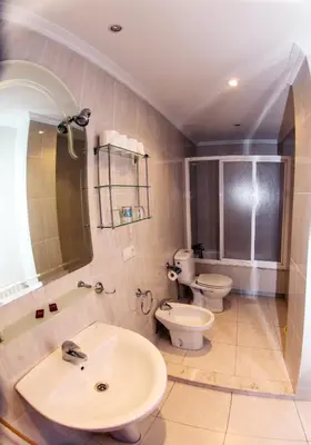 a bathroom with two toilets and a sink at El Molino in Melide