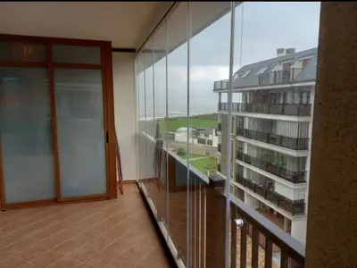 an empty balcony with a view of a building at Dúplex Entero en Foz in Foz