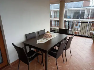 a dining room table with chairs and a cake on it at Dúplex Entero en Foz in Foz