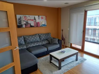 a living room with a couch and a coffee table at Dúplex Entero en Foz in Foz