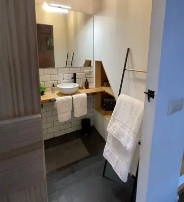 a bathroom with a sink and a mirror at Casa Arroio - Casco antiguo de Allariz in Allariz