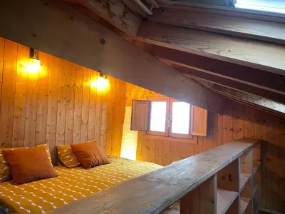 a room with a bed in a wooden wall at Casa Arroio - Casco antiguo de Allariz in Allariz