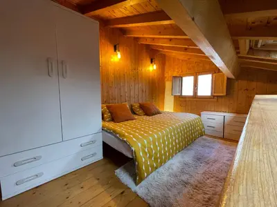 a bedroom with a bed and a dresser in a room at Casa Arroio - Casco antiguo de Allariz in Allariz