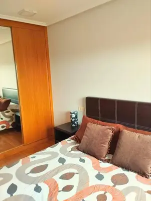 a bedroom with a bed with two pillows on it at Costa SPA Terraza de lujo - Playa las Catedrales in San Miguel de Reinante