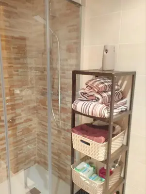 a towel rack in a bathroom with a shower at Costa SPA Terraza de lujo - Playa las Catedrales in San Miguel de Reinante
