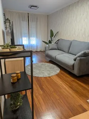 a living room with a couch and a table at O Pisiño de Andrés in Caldas de Reis