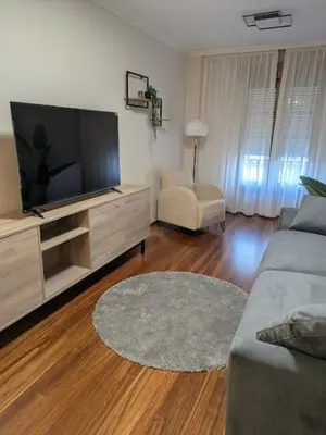 a living room with a large flat screen tv at O Pisiño de Andrés in Caldas de Reis