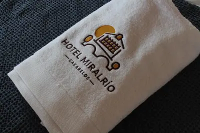 a white piece of paper with a laptop on it at Hotel Miralrio Cacabelos in Cacabelos