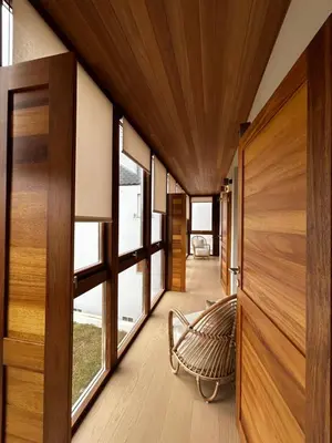 a hallway with wood paneling and a bench in a house at Hotel Miralrio Cacabelos in Cacabelos