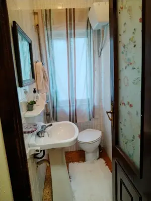 a small bathroom with a sink and a toilet at Casa Albergue PTY in Sarria