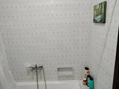 a white bathroom with a tub and a sink at Casa Albergue PTY in Sarria
